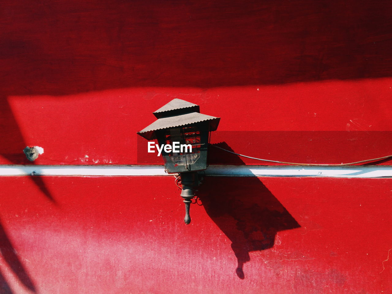 Red boat moored in water