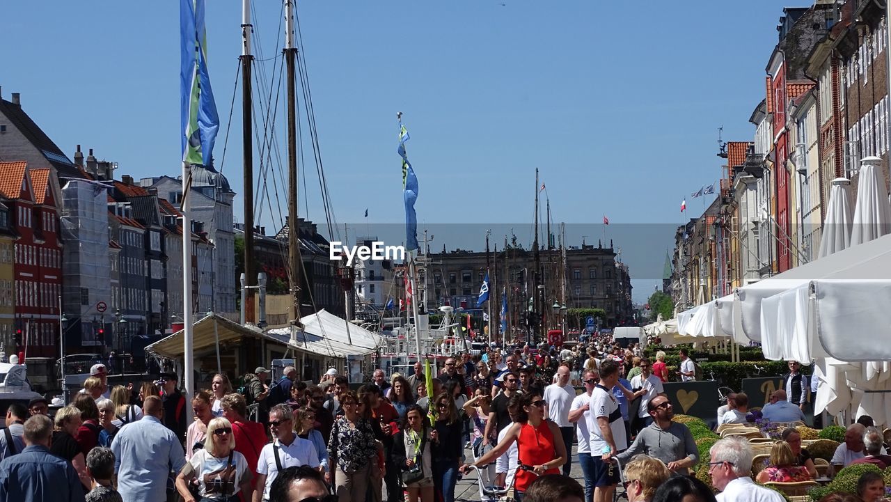 PANORAMIC VIEW OF CROWD ON STREET IN CITY