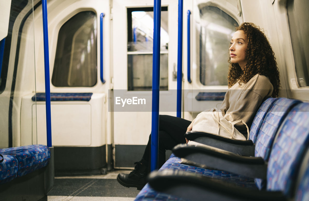 Contemplative woman sitting in subway train