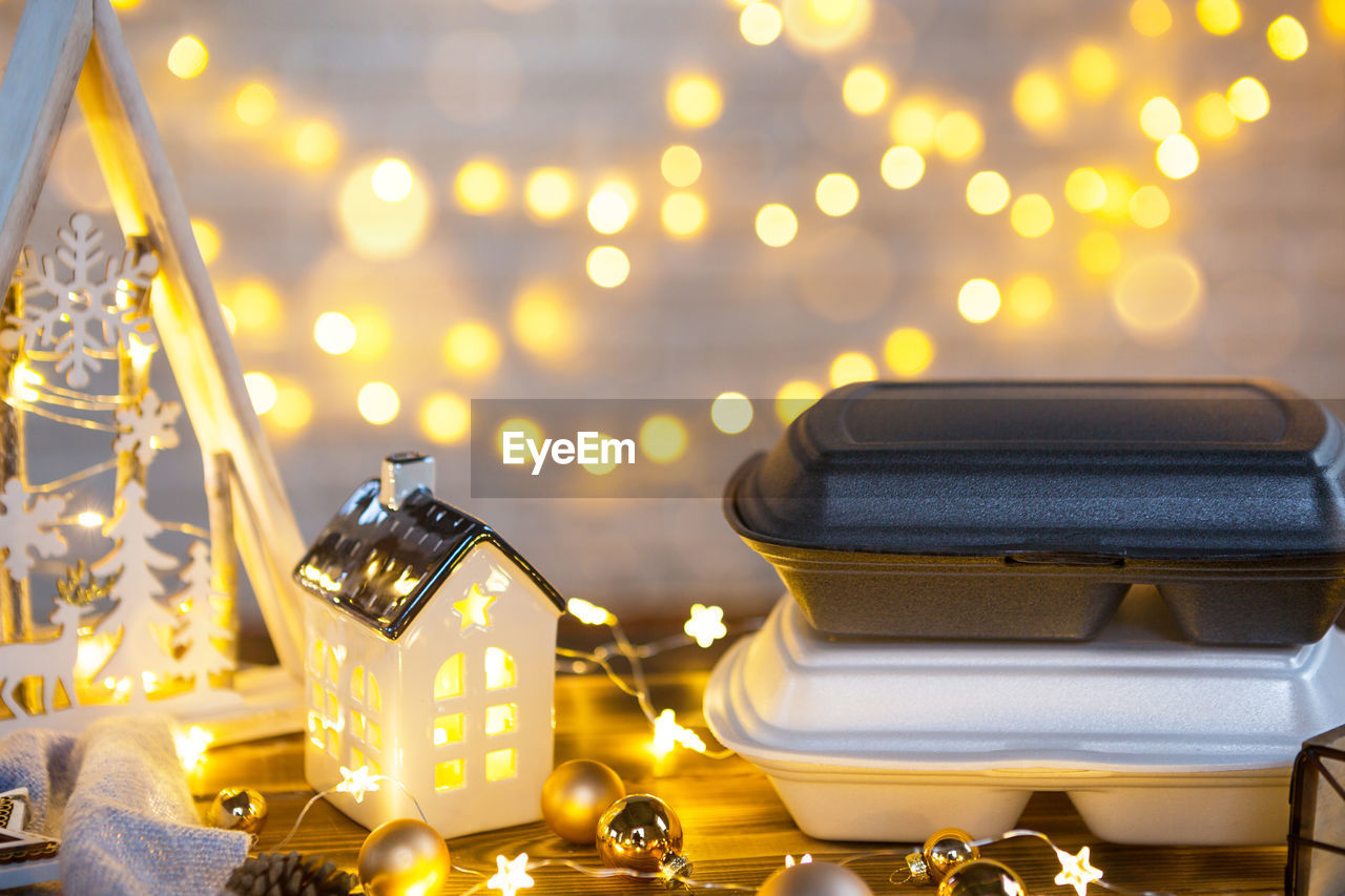 CLOSE-UP OF CHRISTMAS LIGHTS ON TABLE