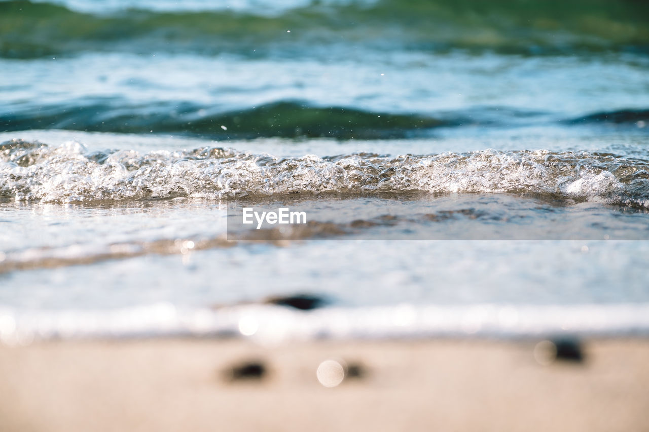 Close-up of waves rushing towards shore