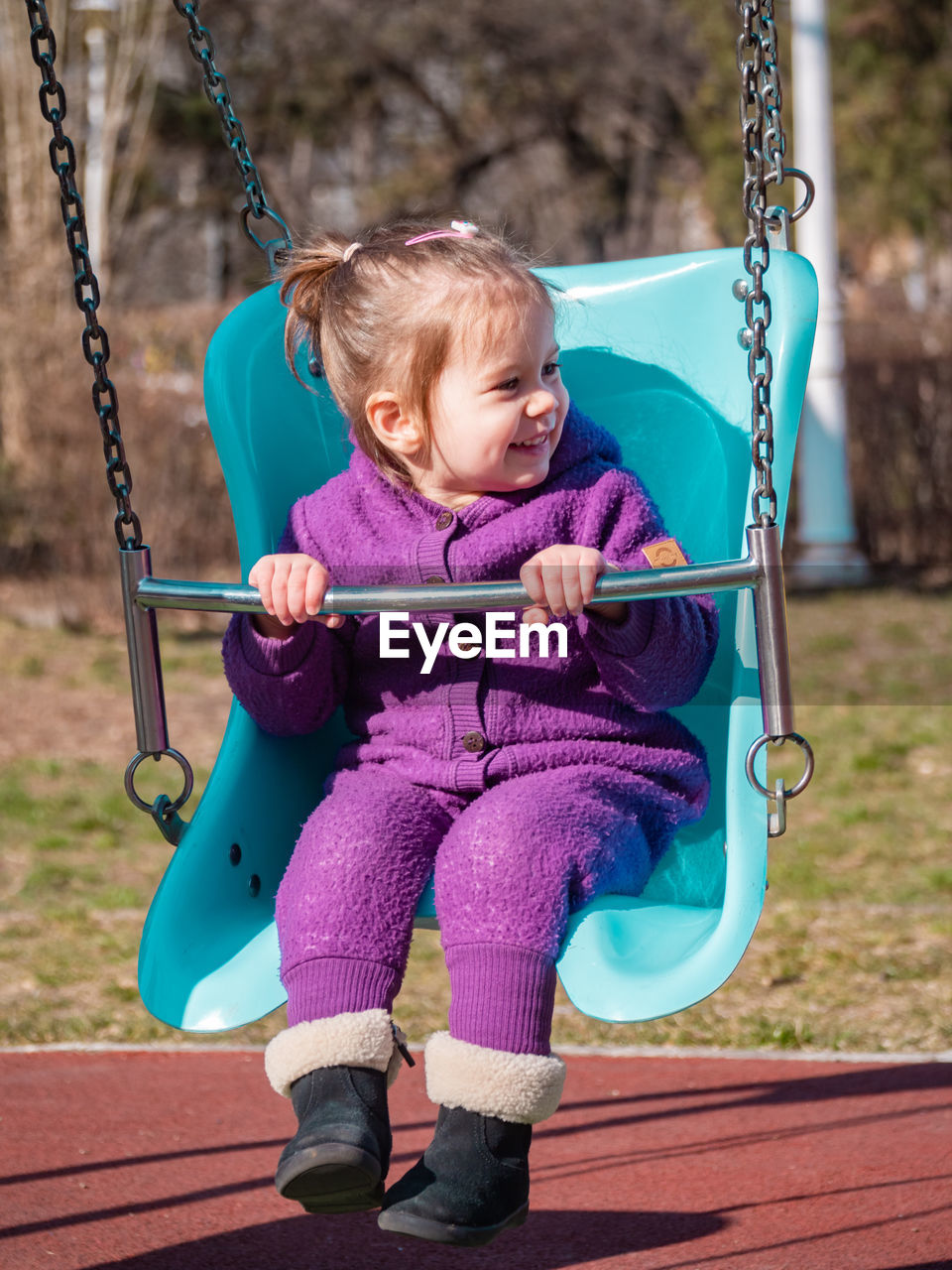 Portrait of girl swinging at playground