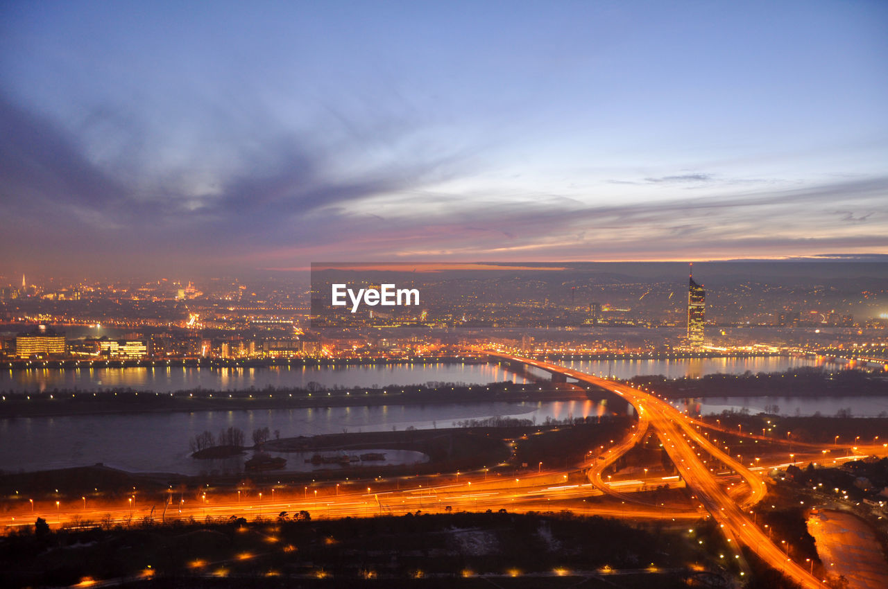 Aerial view of city lit up at sunset