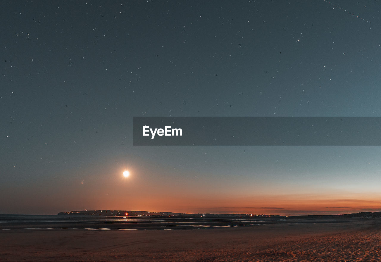 Scenic view of sea against sky at night