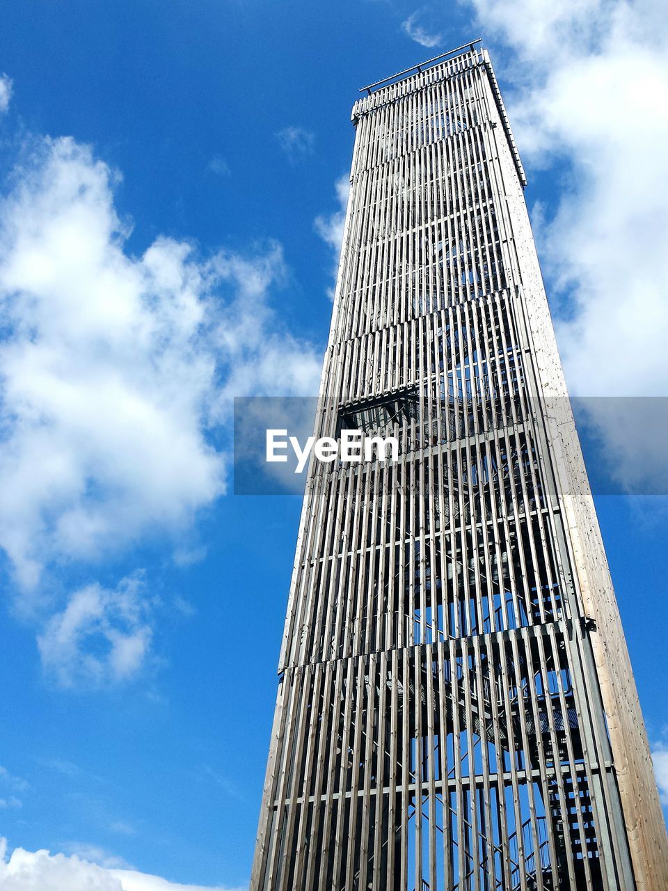 Low angle view of skyscrapers against blue sky