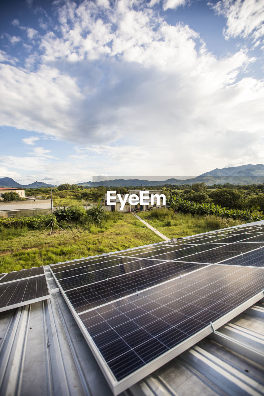 High angle of solar panels on roof of rural building in guatemala.