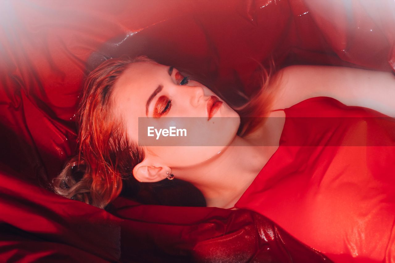 High angle view of young woman sleeping in bathtub