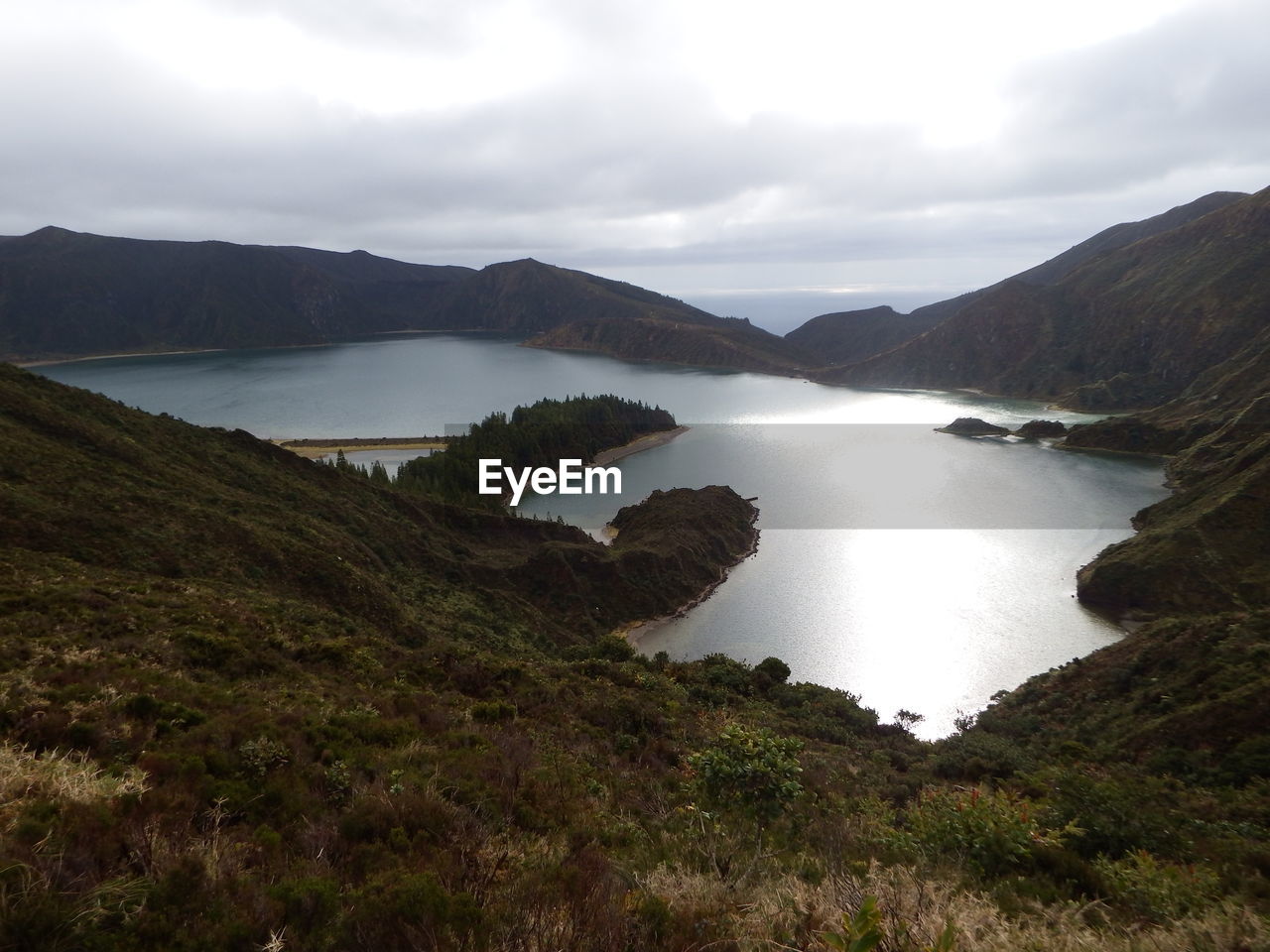 Scenic view of lake and mountains against sky
