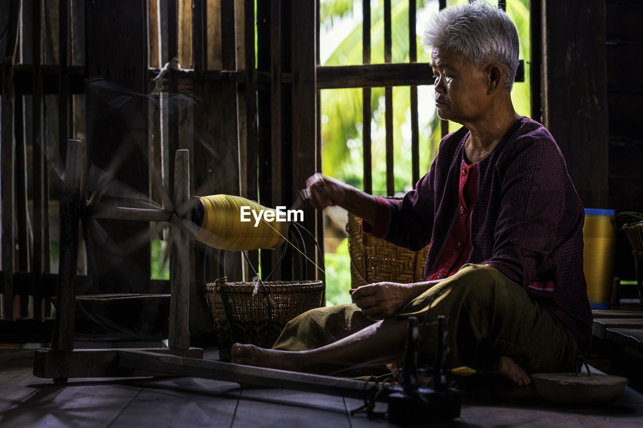 Senior woman working on loom