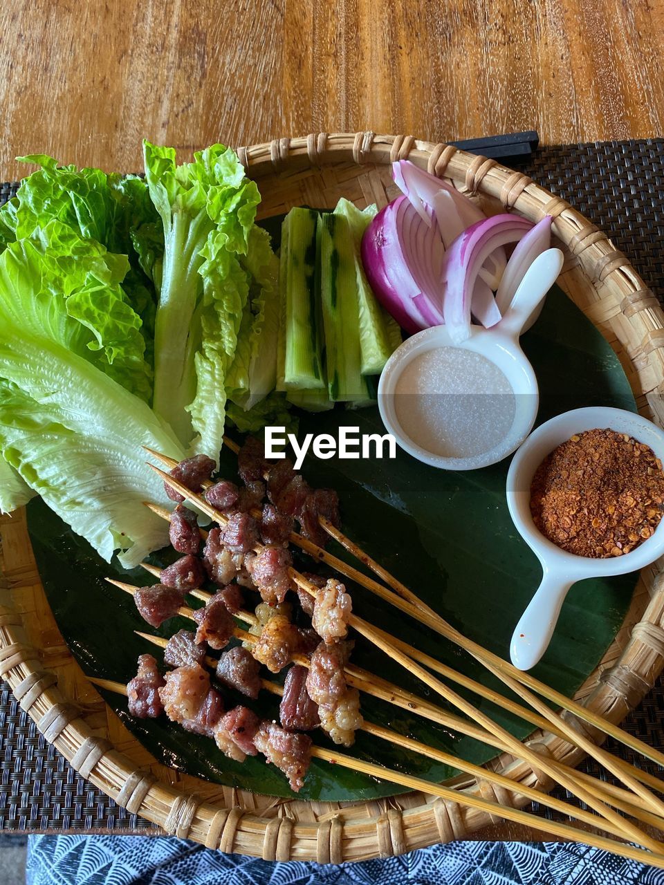 HIGH ANGLE VIEW OF VEGETABLES AND LEAVES IN BOWL ON TABLE
