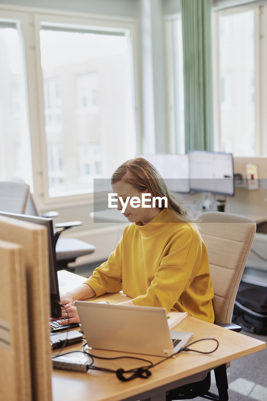 Woman using computer in office