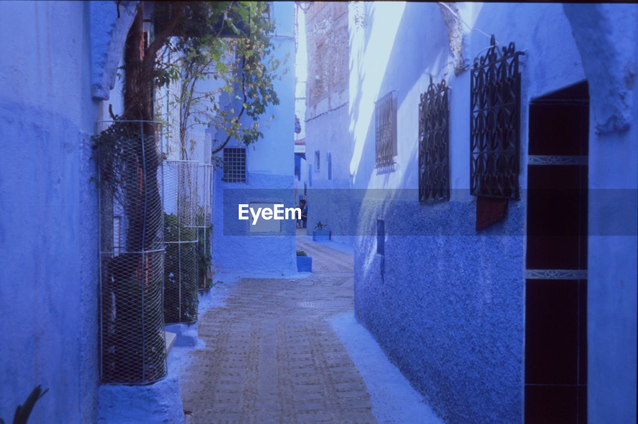 ALLEY AMIDST HOUSES AND BUILDING