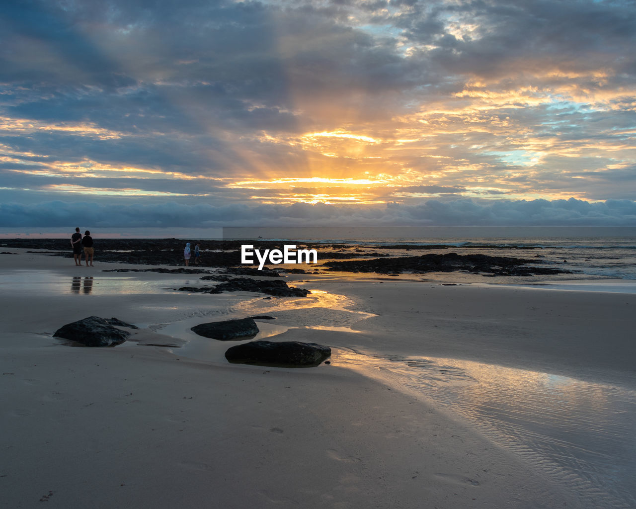 SCENIC VIEW OF BEACH DURING SUNSET