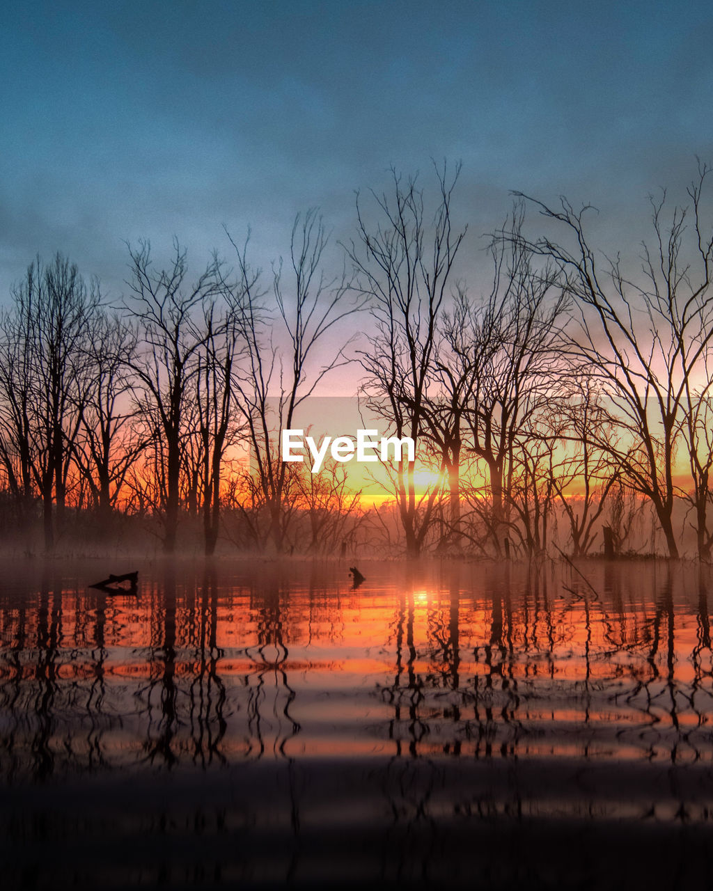 Scenic view of lake against sky during sunset