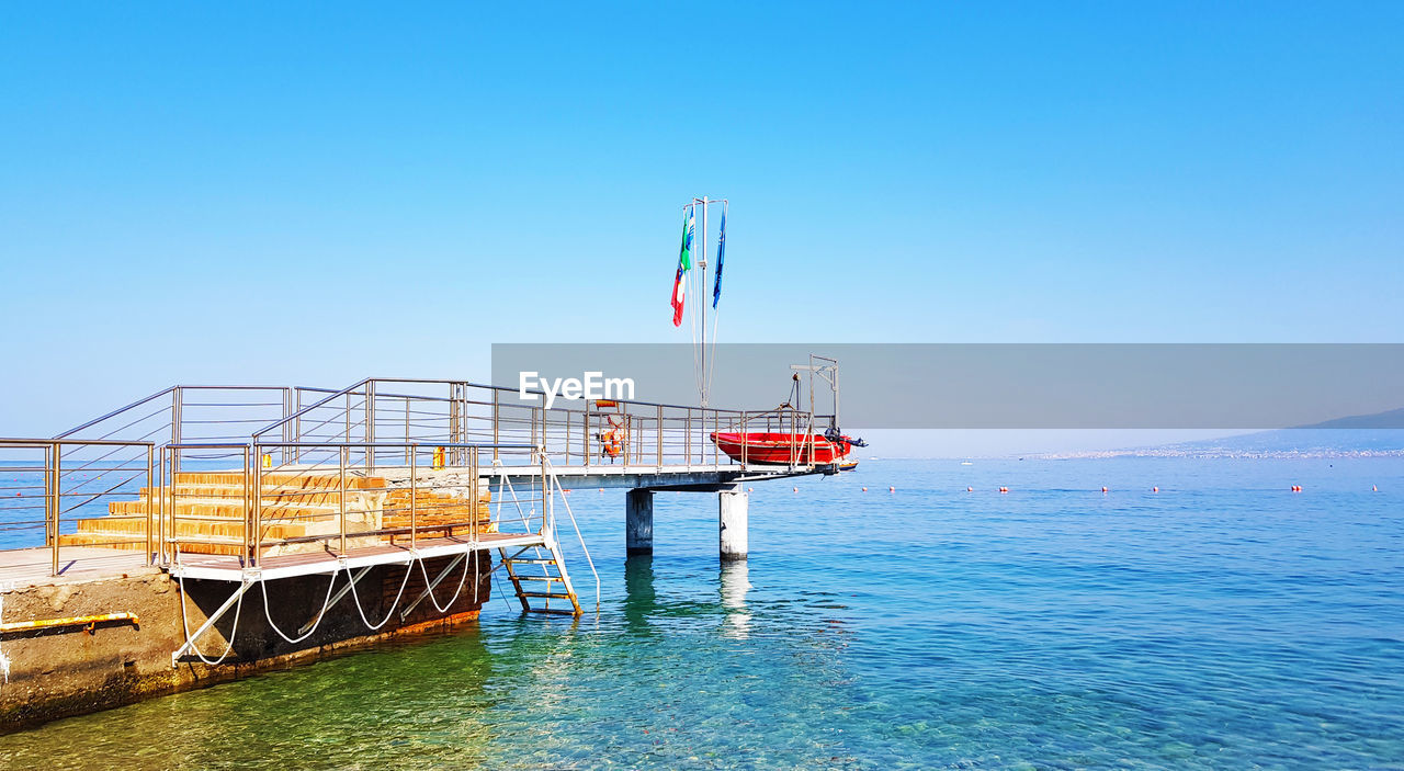 Scenic view of sea against clear blue sky