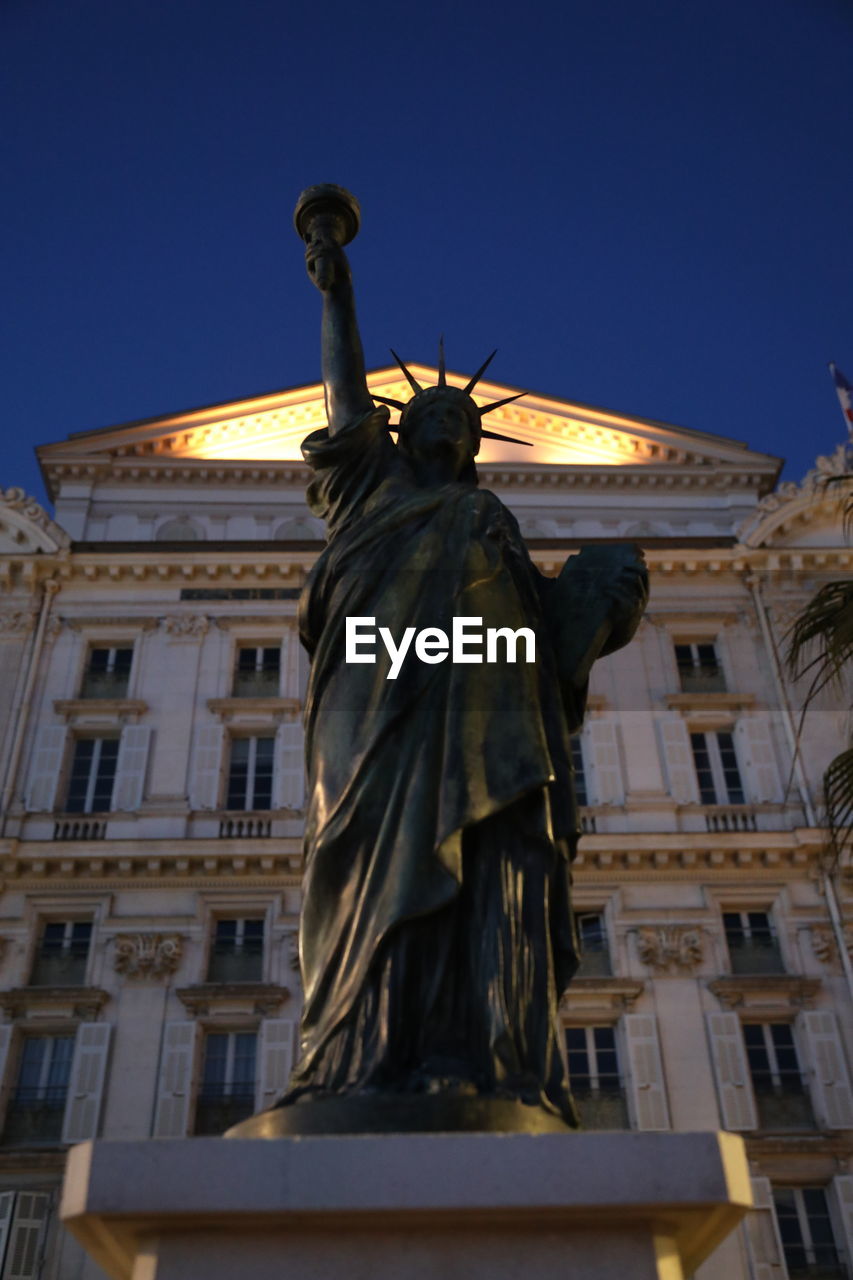 LOW ANGLE VIEW OF STATUE IN CITY