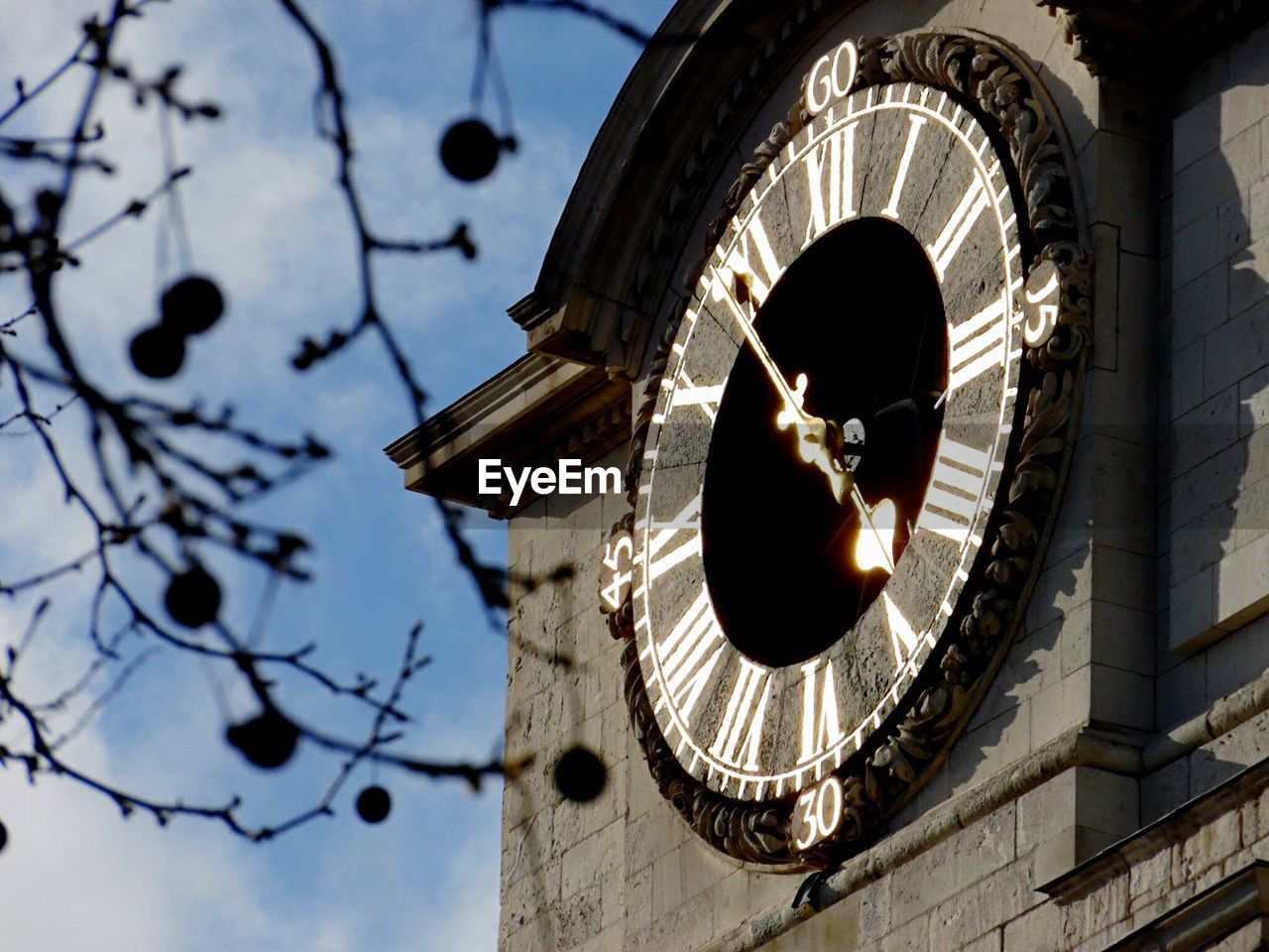 Low angle view of clock tower against sky