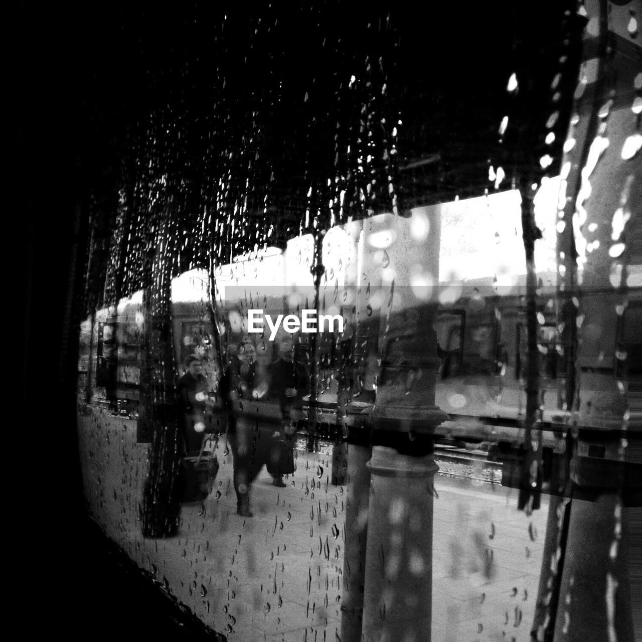 Reflection of railroad station on glass during rainy season