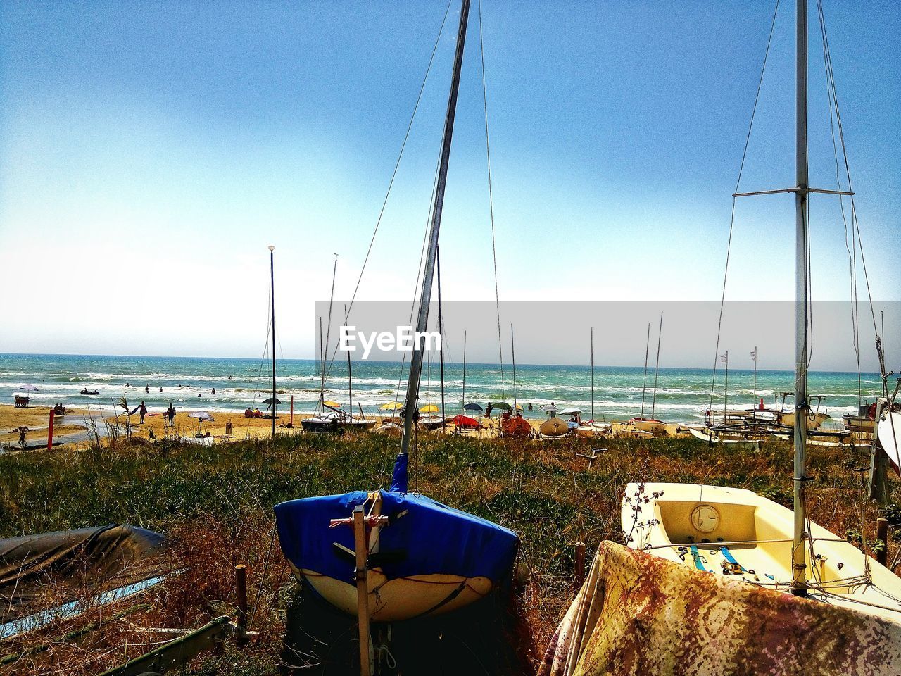 SAILBOATS MOORED ON SEA AGAINST SKY