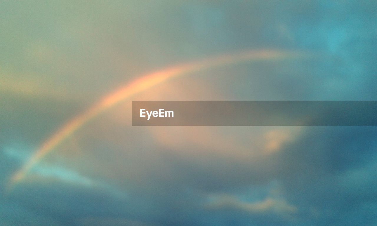 RAINBOW AGAINST SKY AT SUNSET