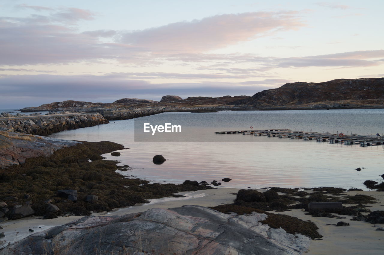 SCENIC VIEW OF ROCKS IN SEA AGAINST SKY