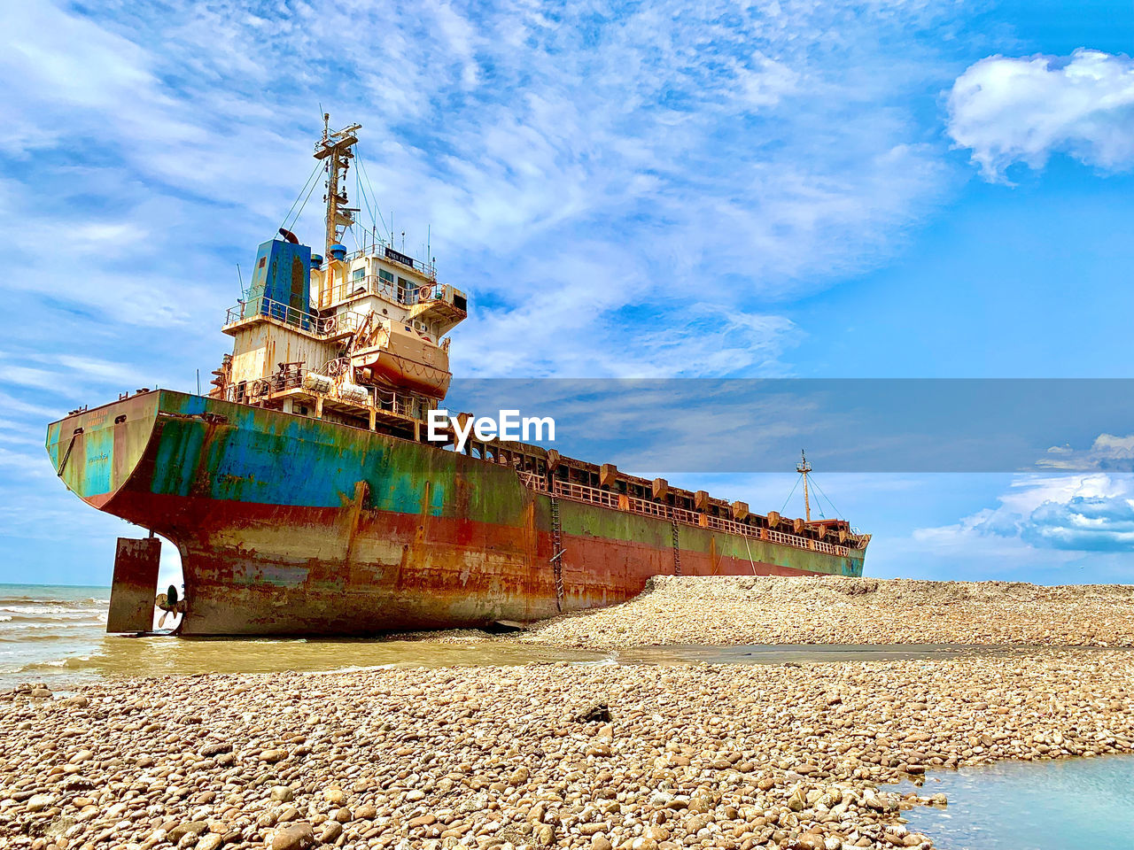 LOW ANGLE VIEW OF ABANDONED SHIP ON BEACH