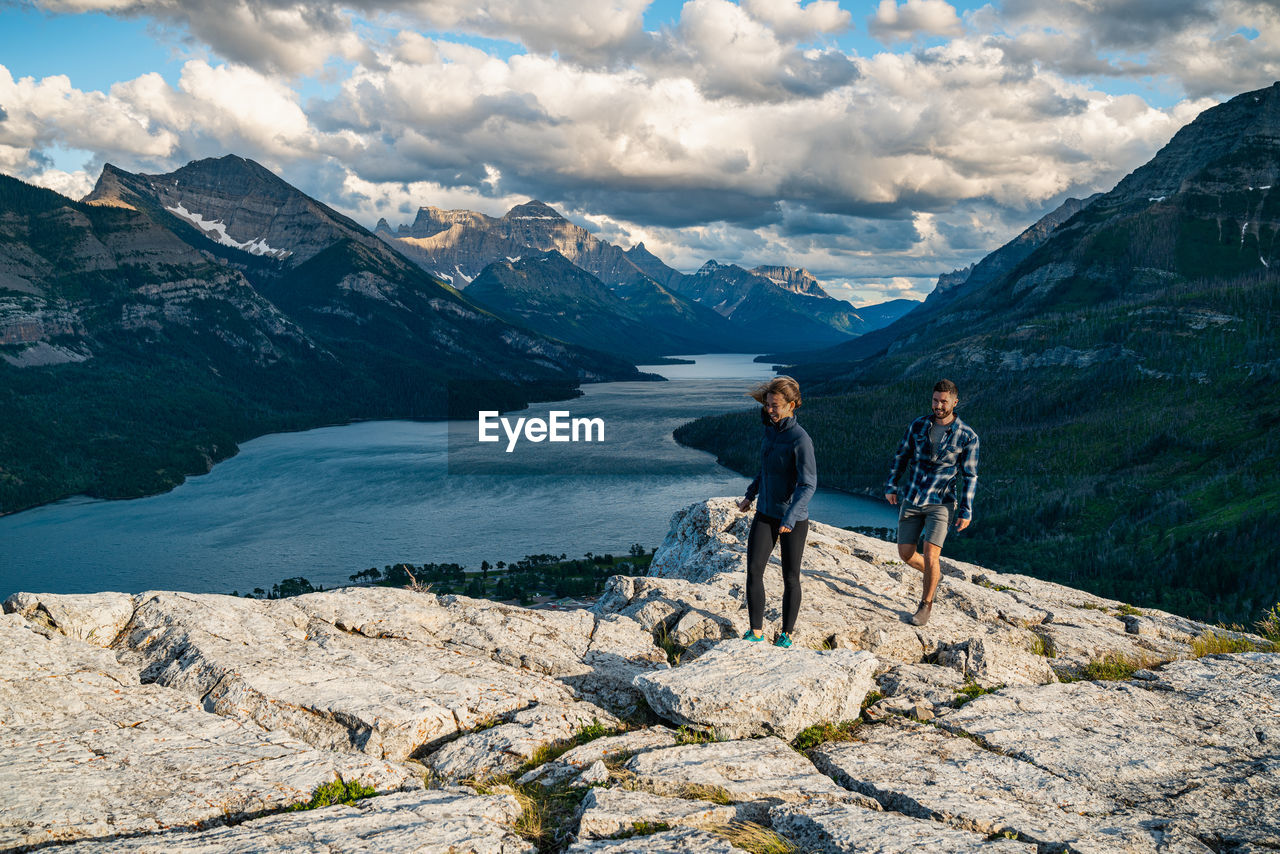 Couple hiking on bear's hump mountain in waterton lakes national park