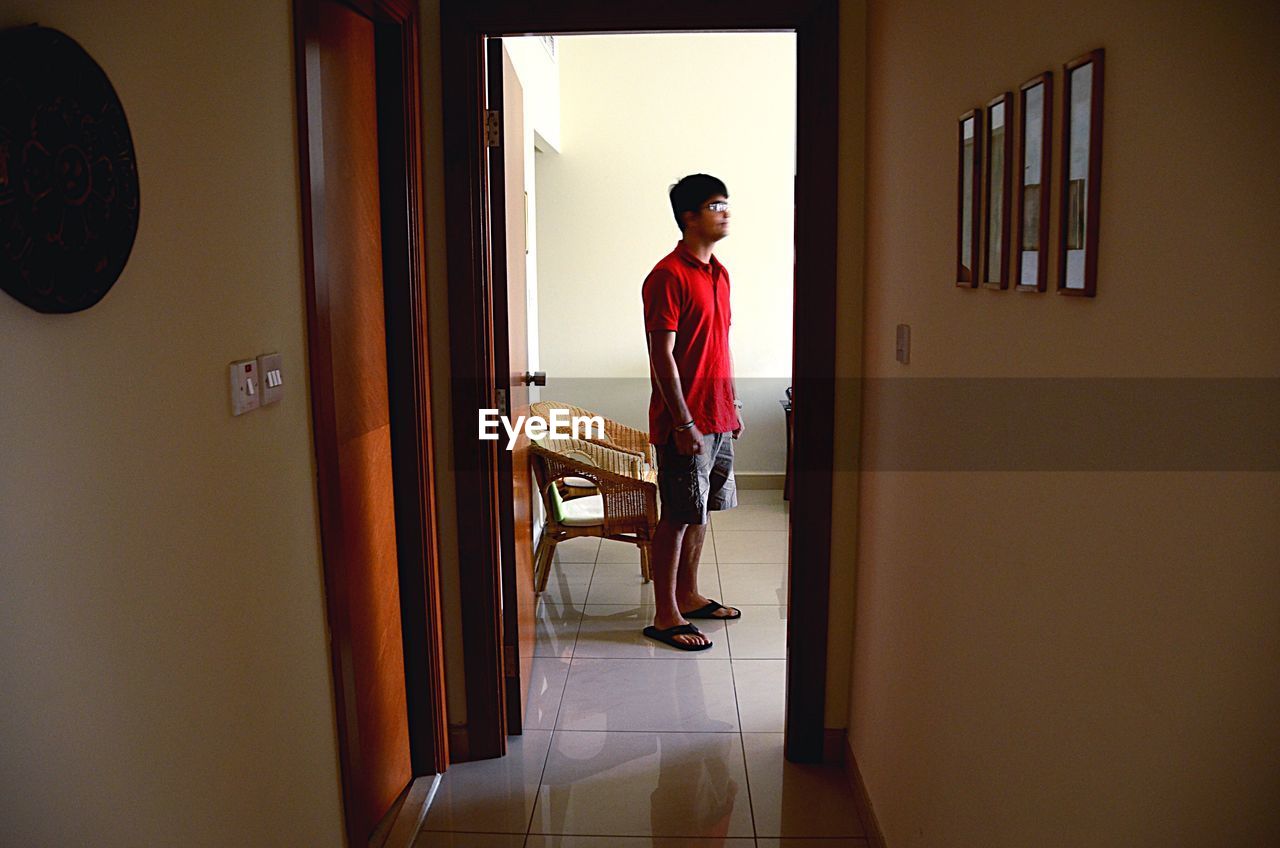 Man standing against wall at home