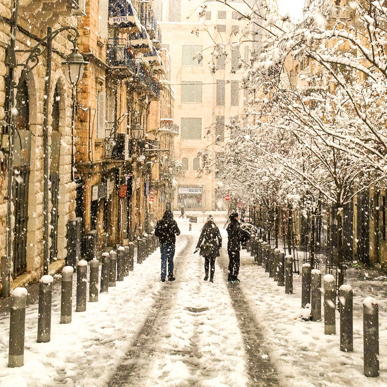 People walking on snow covered city