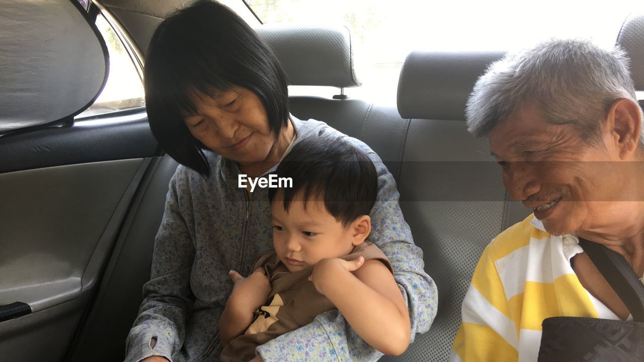 Family sitting in car