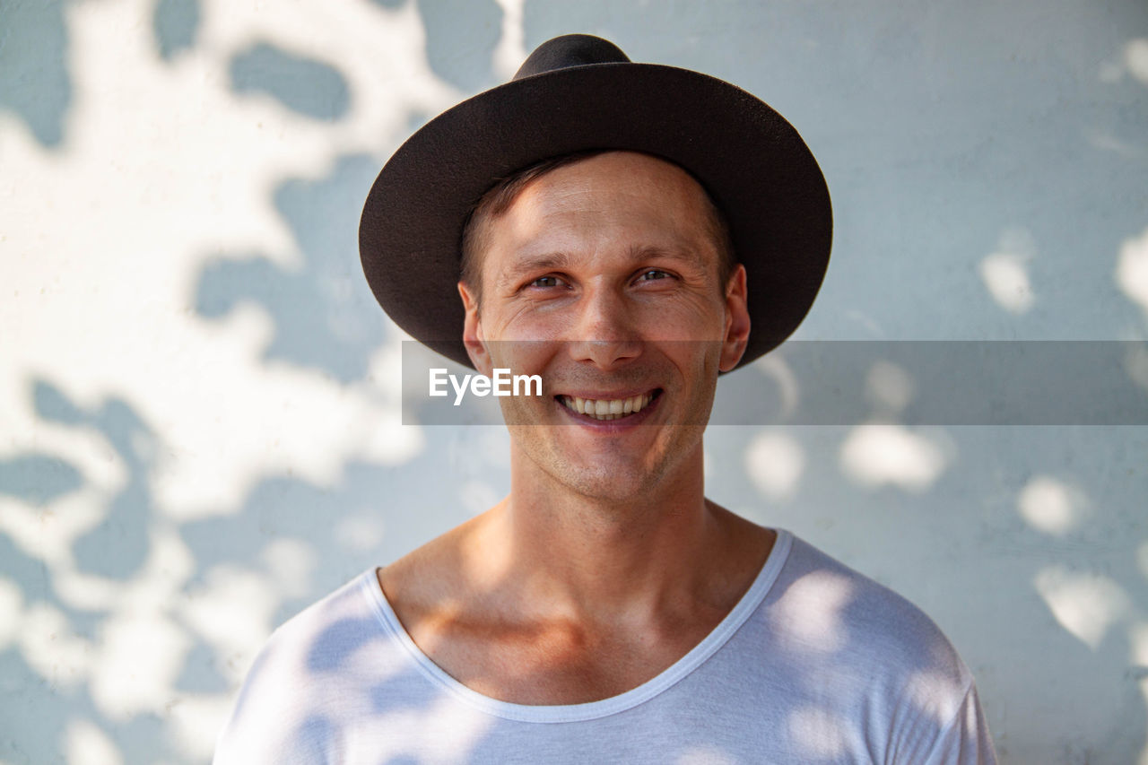 Portrait of young man wearing hat smilling to camera 