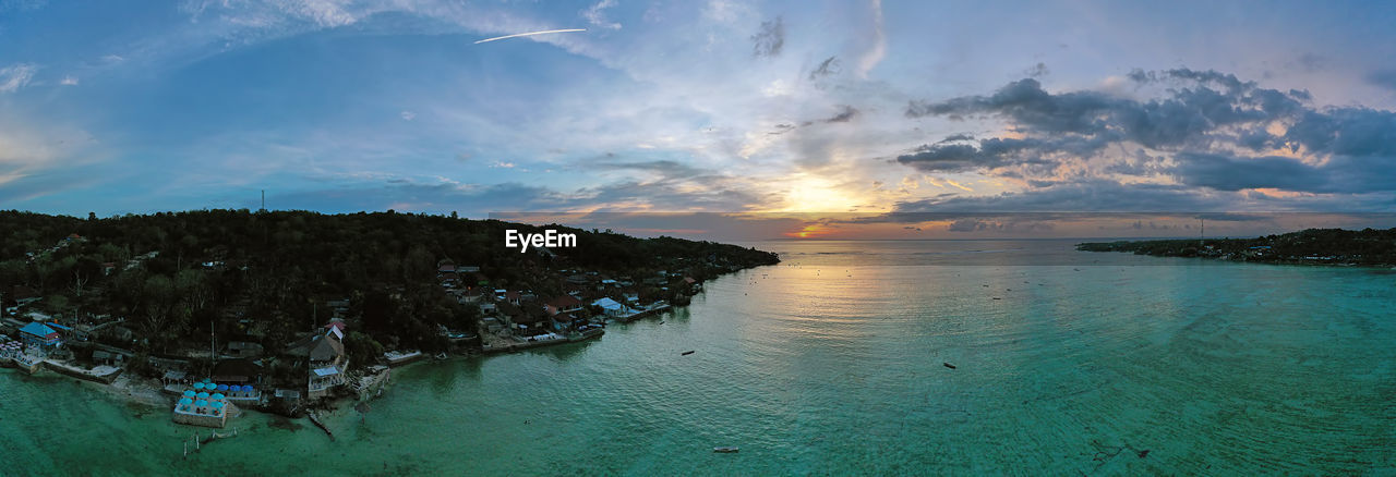 PANORAMIC SHOT OF SEA AGAINST SKY DURING SUNSET