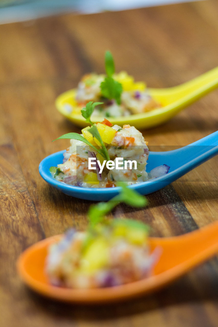 Close-up of food served in spoons on table