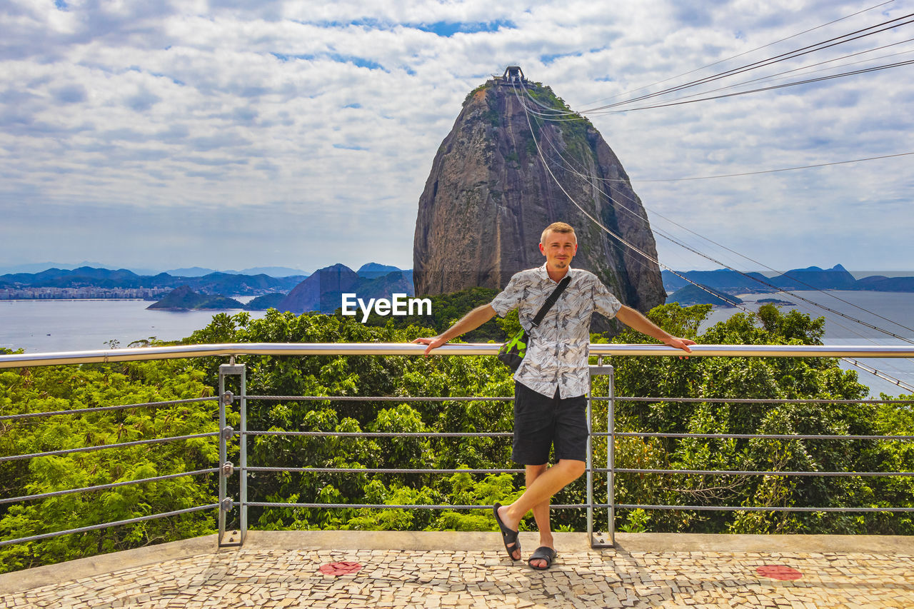 Tourist traveler poses at sugarloaf mountain rio de janeiro brazil.