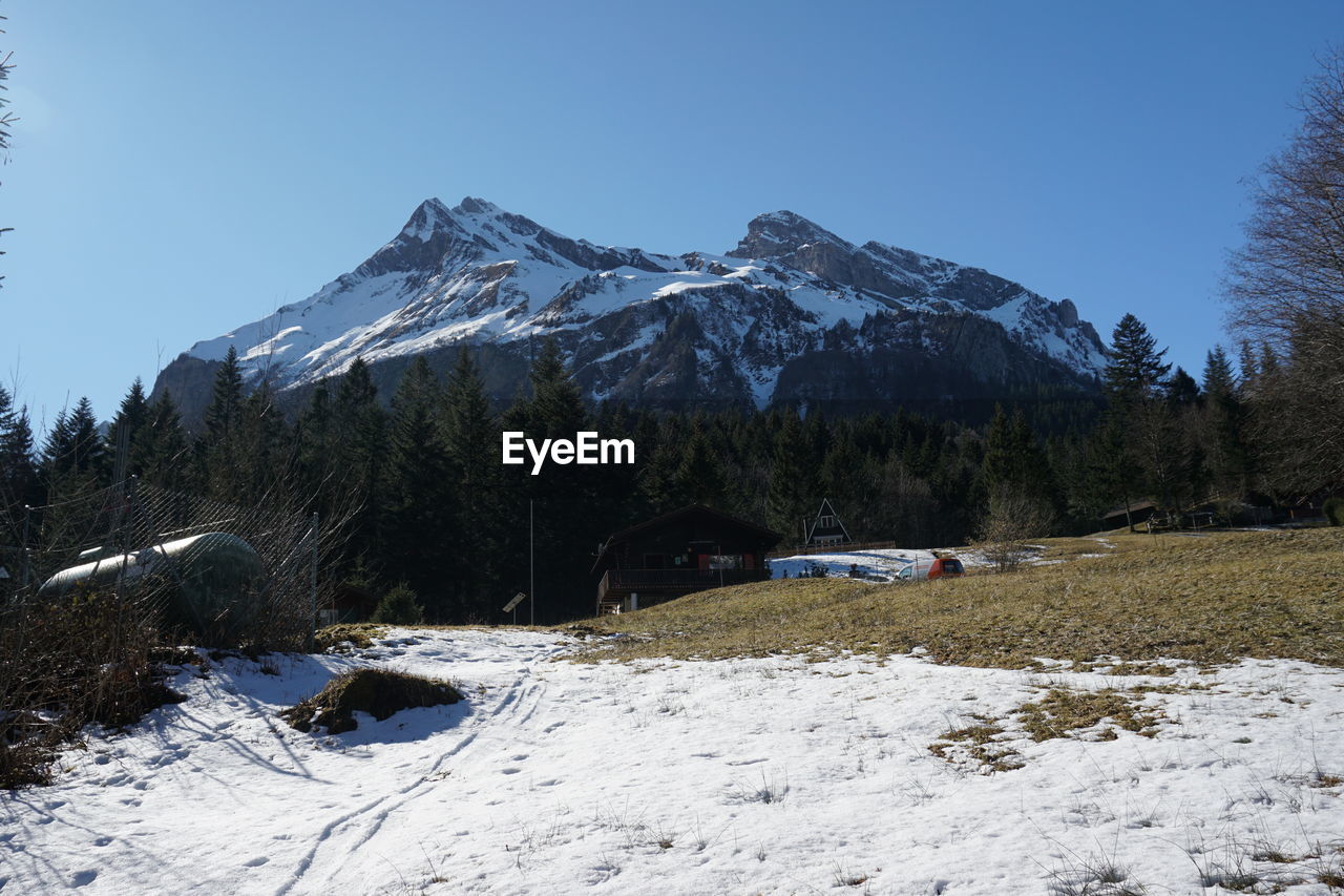 Scenic view of snow covered mountains against clear sky