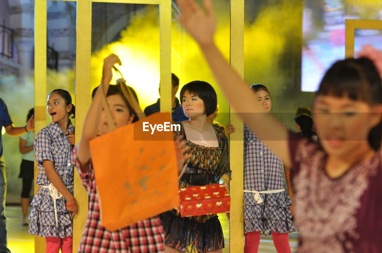 Artists performing dance with shopping bags during carnival