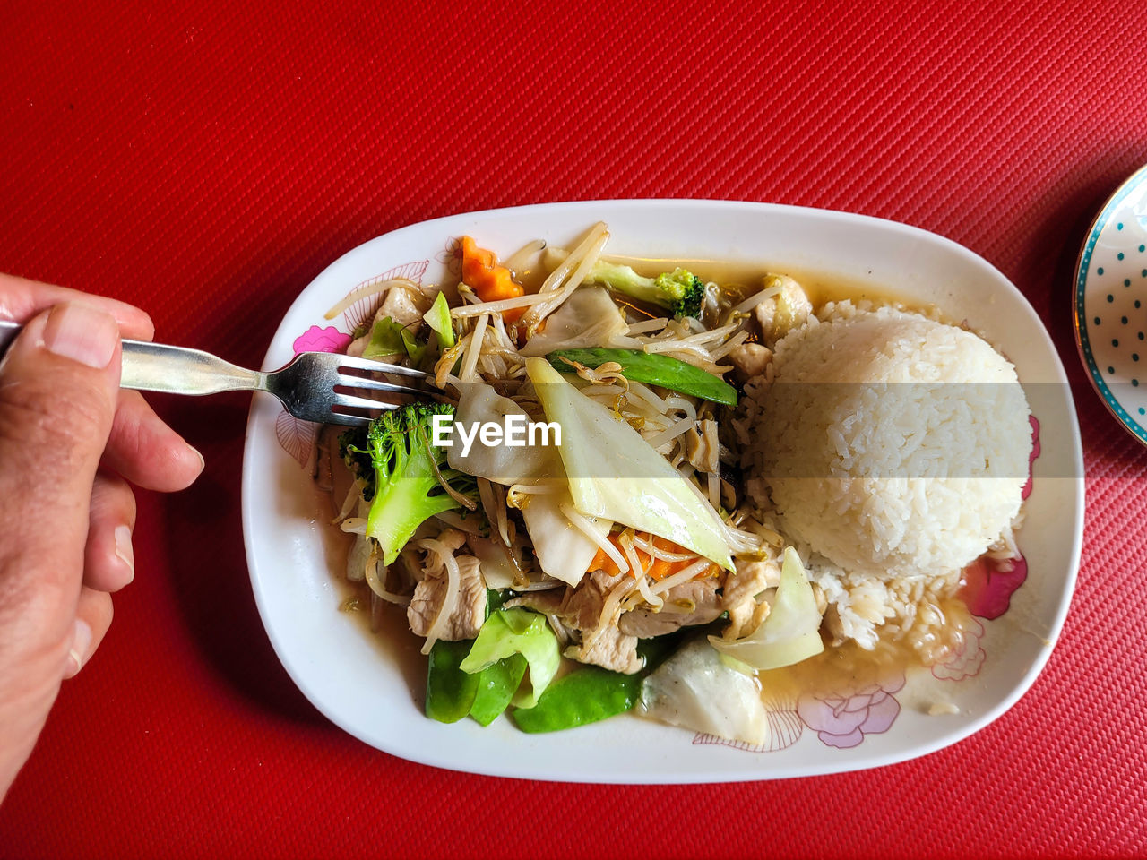 Man eating thai food in a thai restaurant.