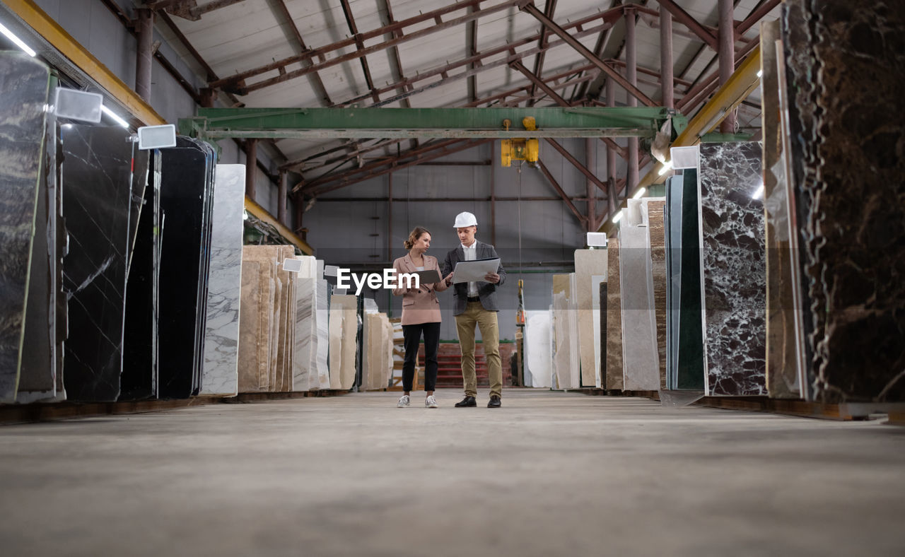 Adult workers in marble warehouse