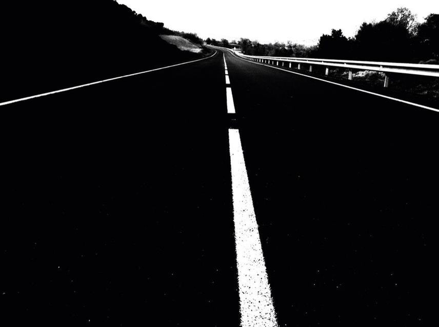 EMPTY ROAD ALONG TREES