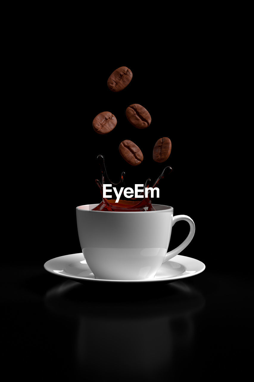 CLOSE-UP OF COFFEE CUP AND BLACK BACKGROUND