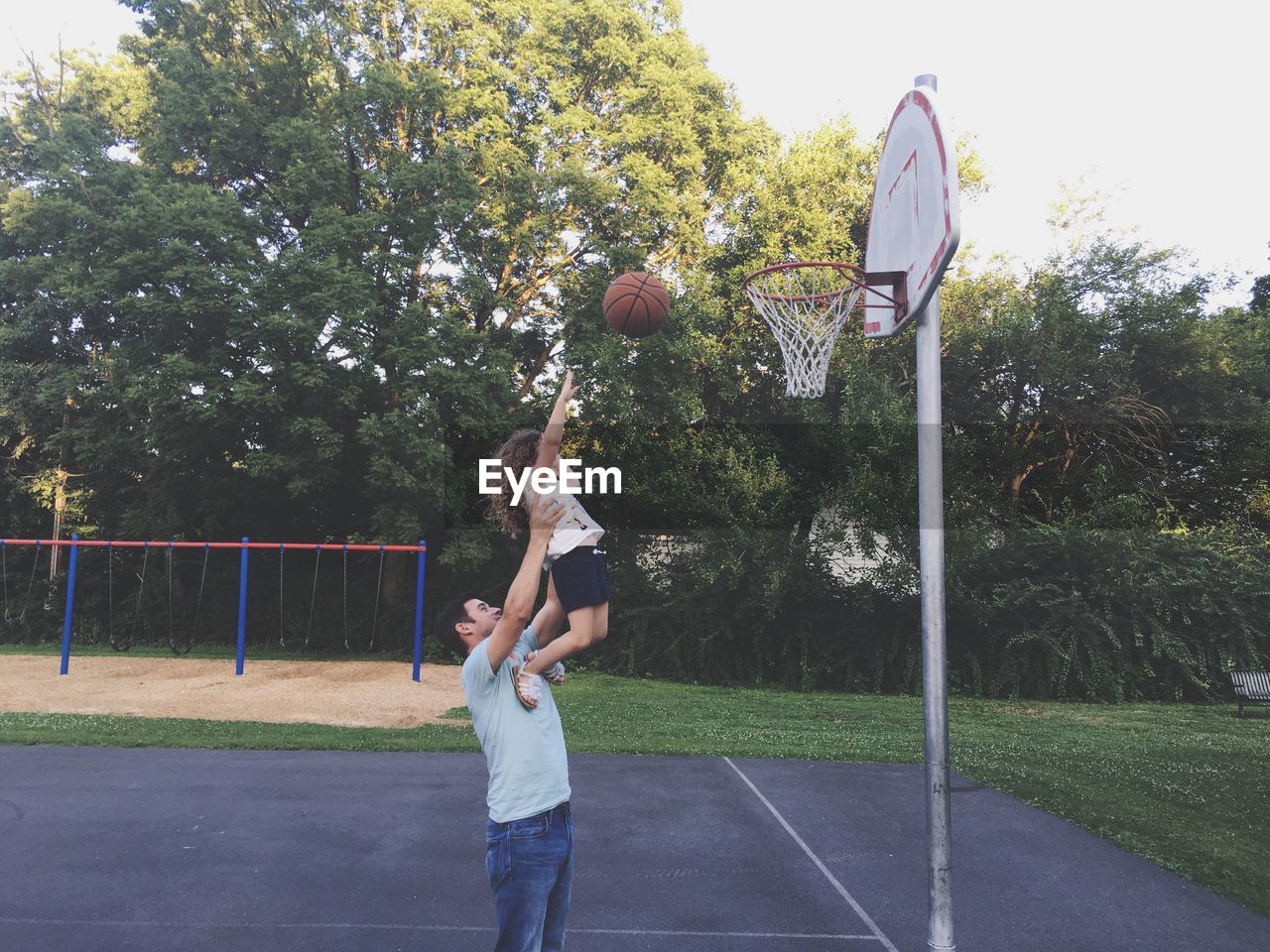 Father and daughter playing basketball