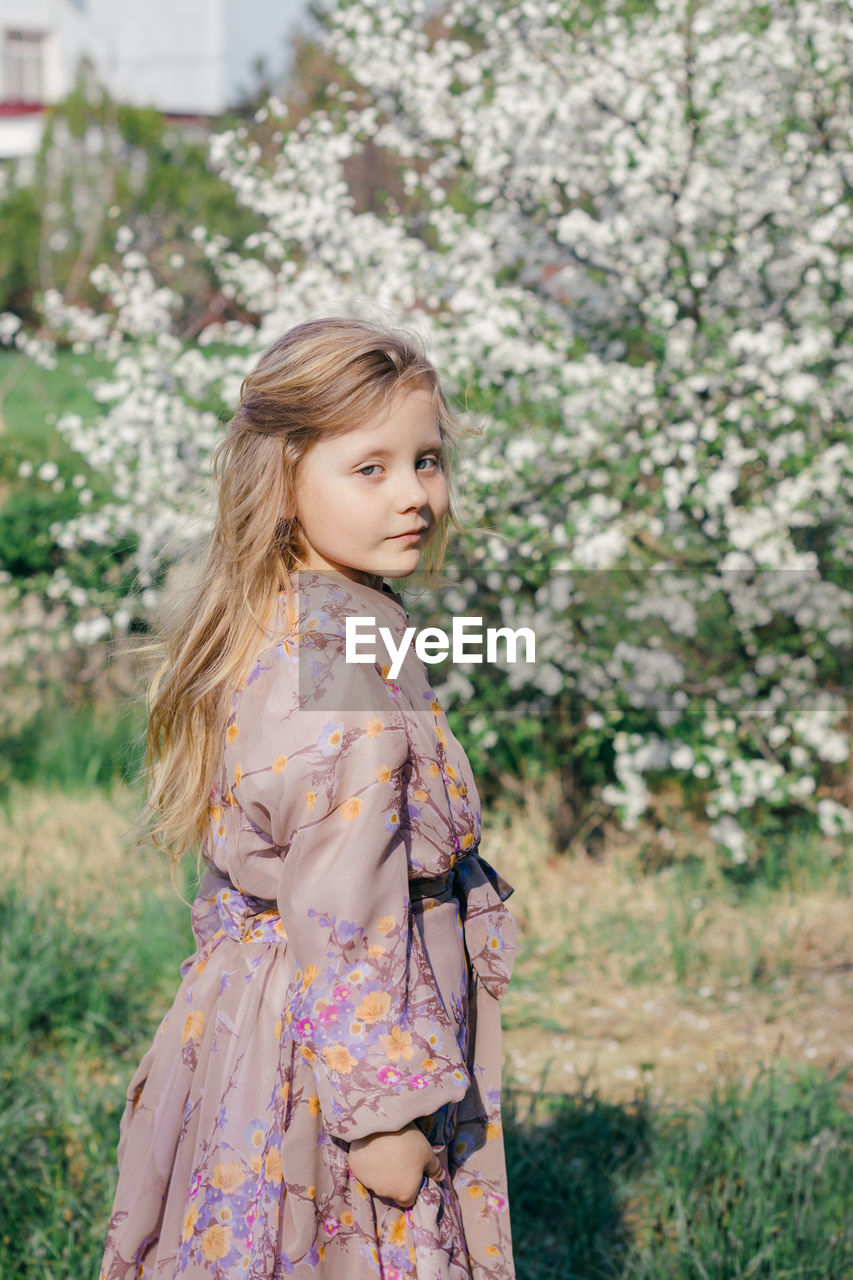 Spring, portrait on a background of blossoming cherry