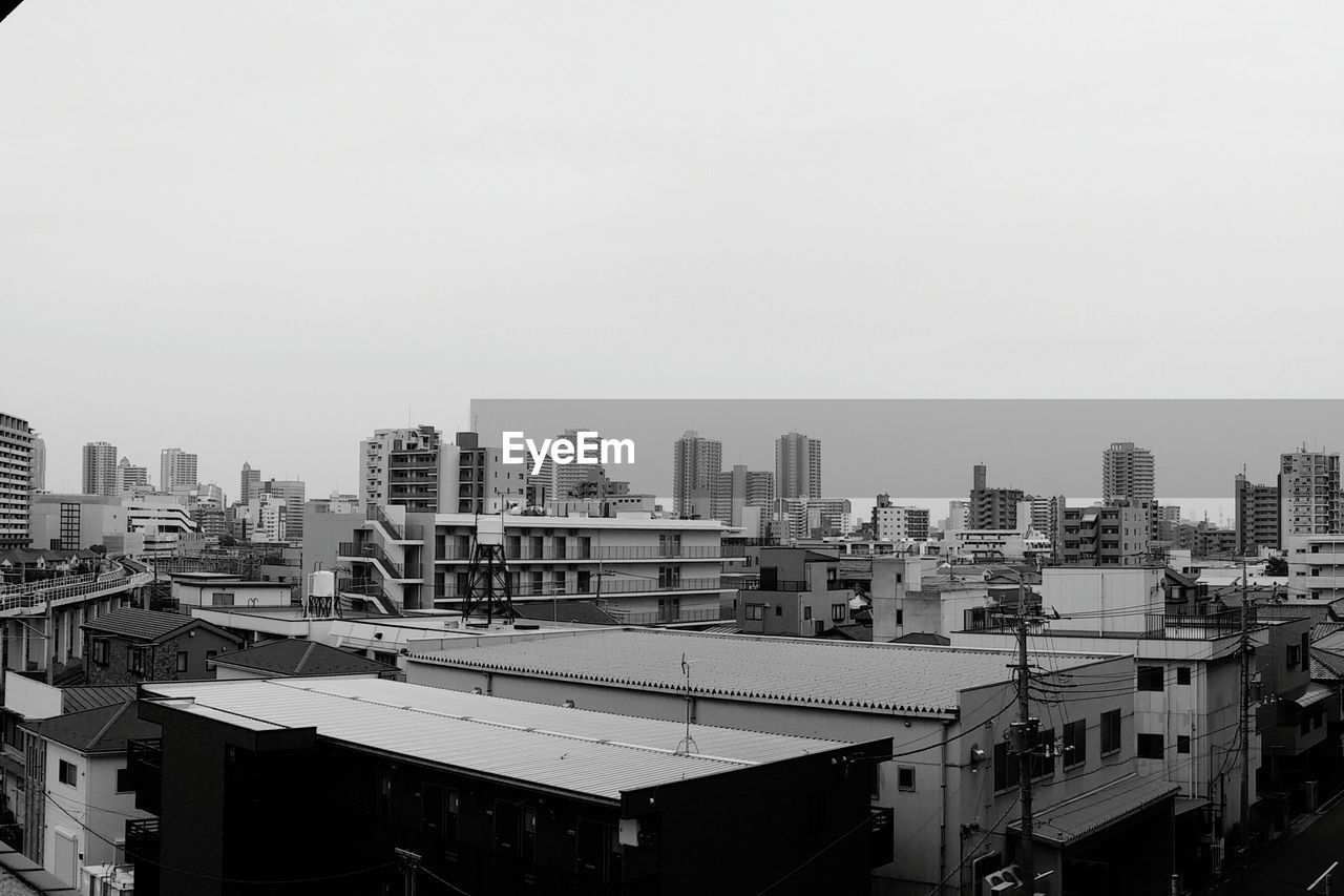 Buildings in city against clear sky