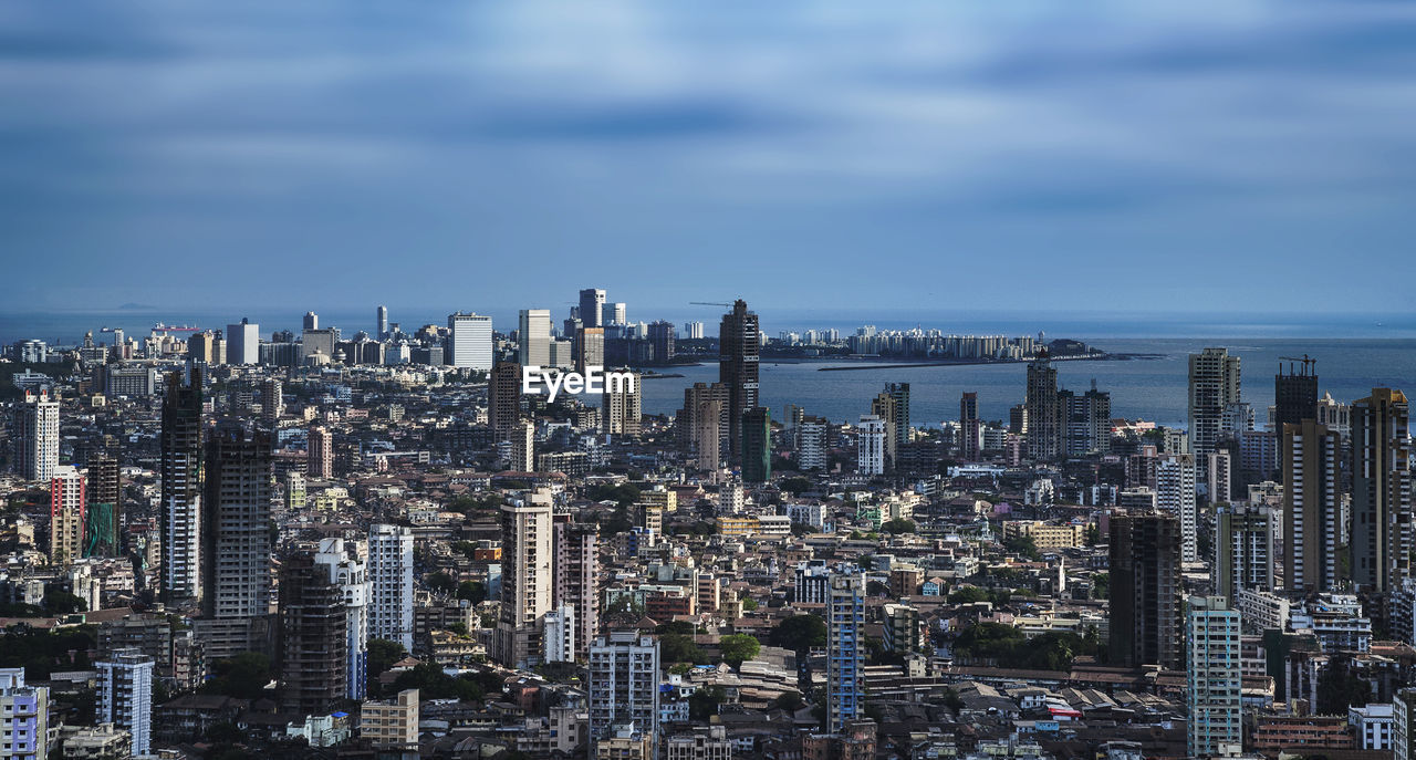 Aerial view of modern buildings in city against sky