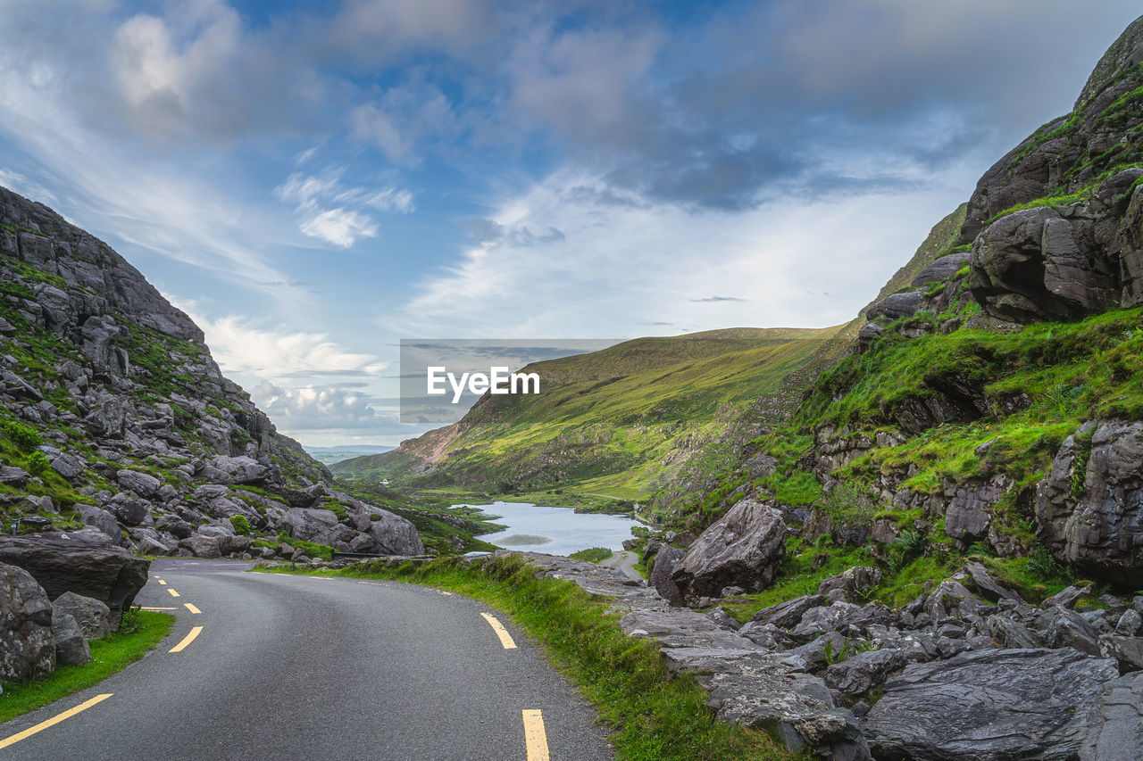 EMPTY ROAD AGAINST MOUNTAINS