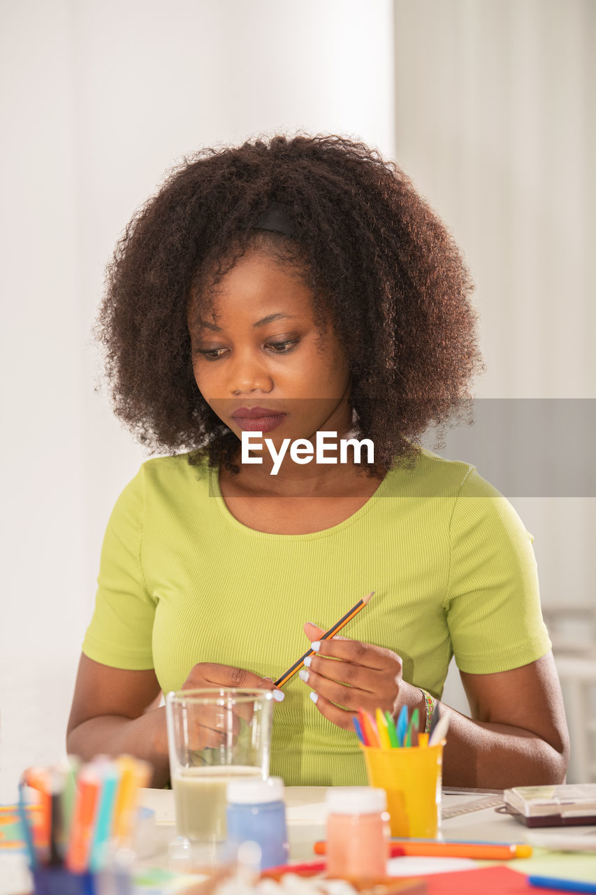 Woman sitting by table