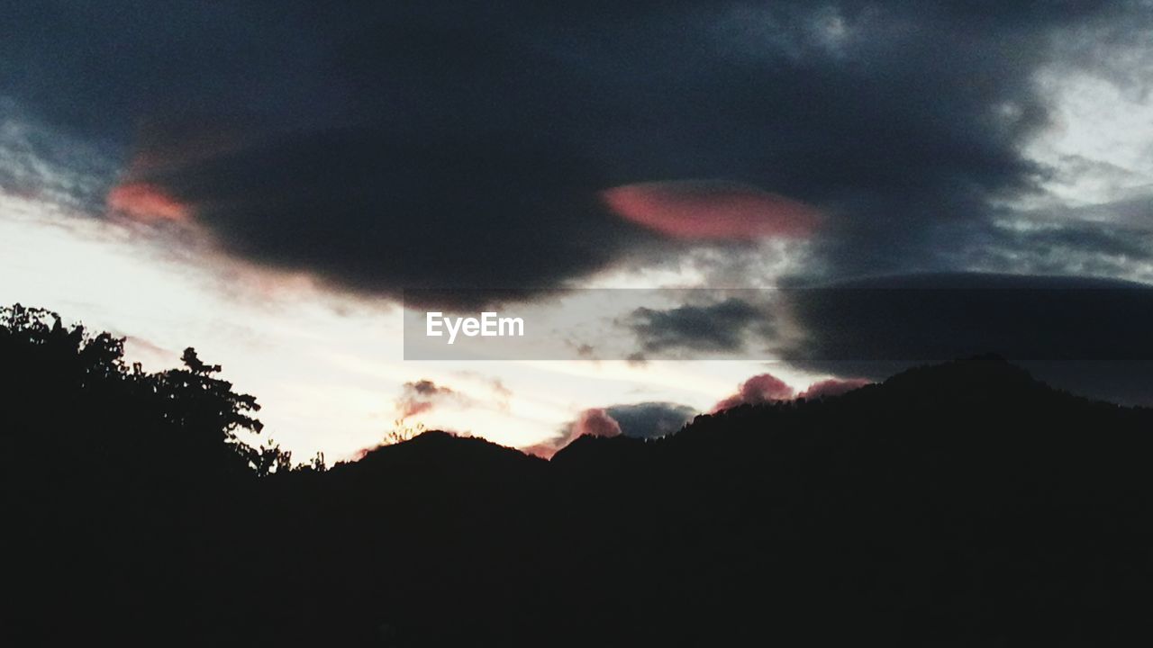 SILHOUETTE MOUNTAINS AGAINST SKY DURING SUNSET