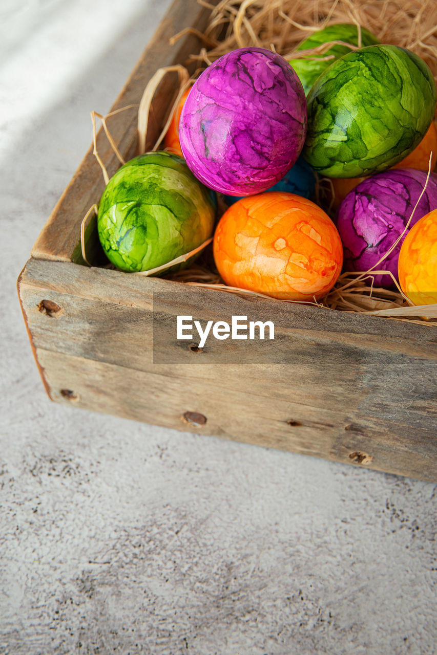 food, food and drink, multi colored, still life, high angle view, wood, freshness, no people, vegetable, healthy eating, tradition, variation, wellbeing, container, produce, easter, indoors, easter egg, egg, basket, yellow, studio shot, cabbage, purple, green, close-up