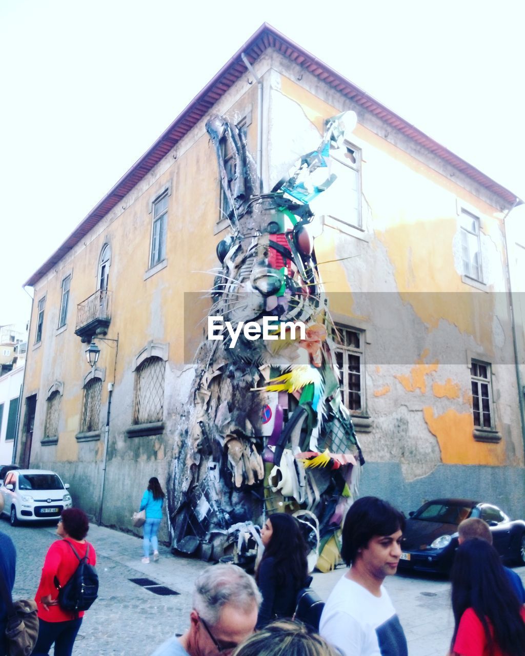 PEOPLE ON STREET AGAINST BUILDINGS