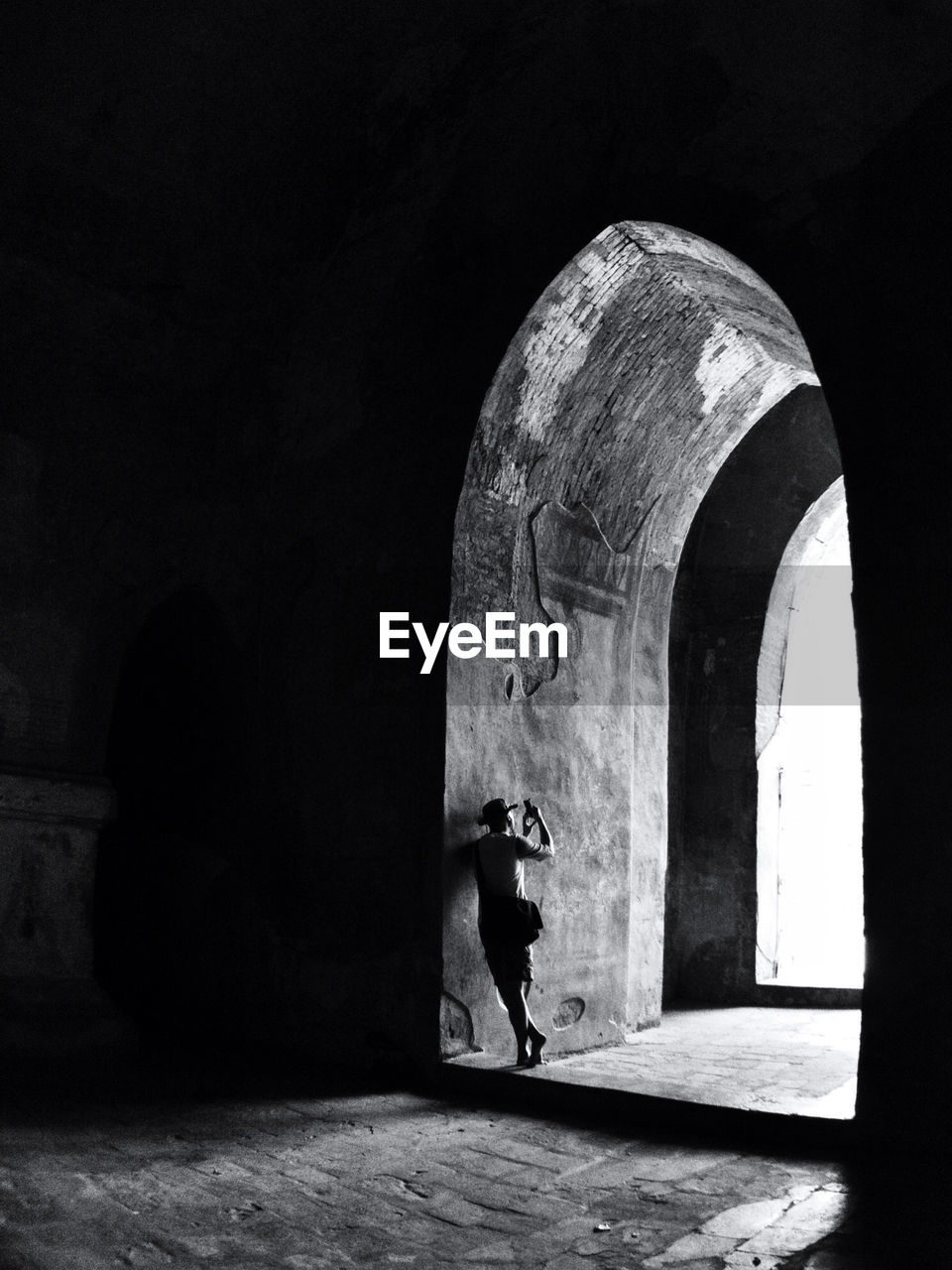 Man photographing inside historical building in city